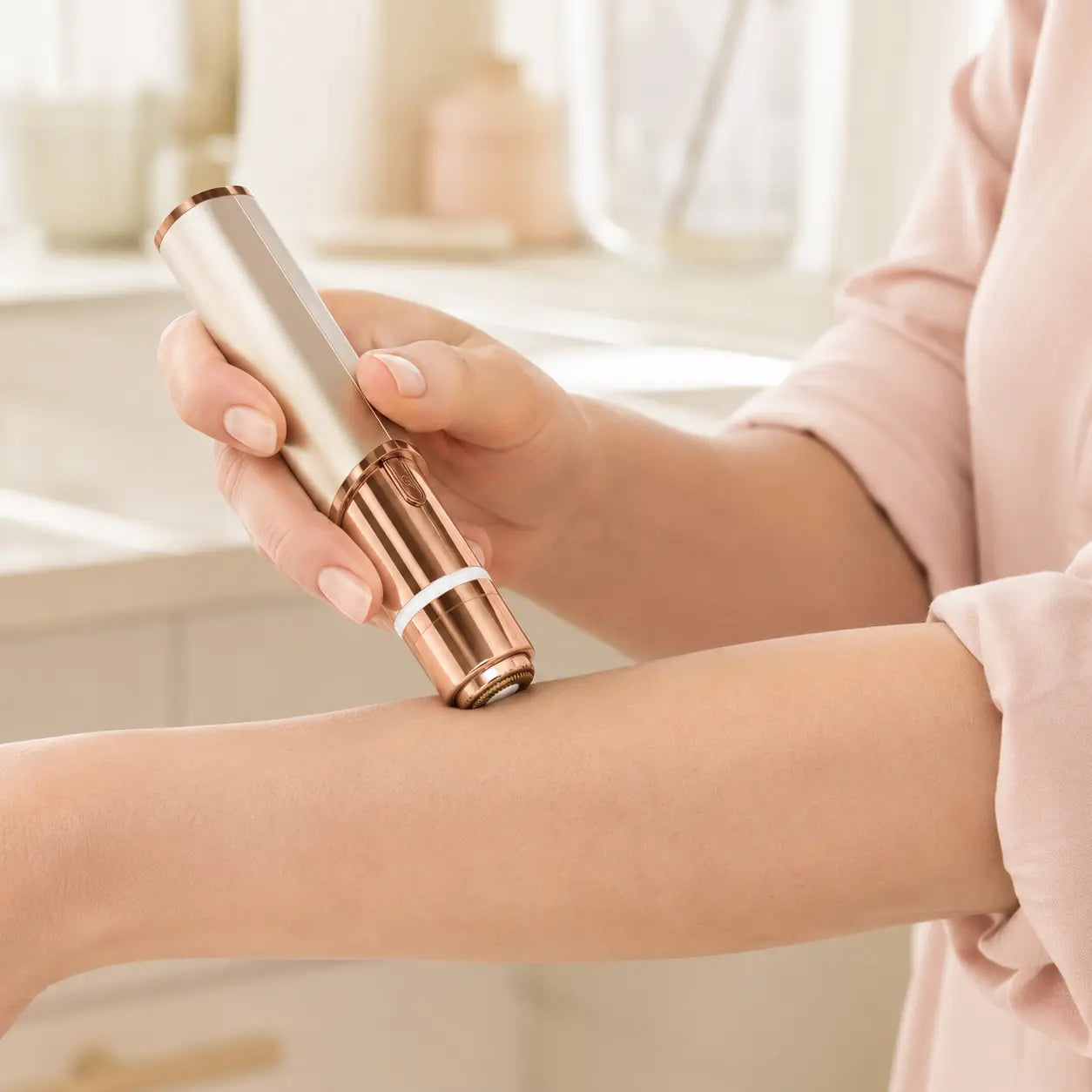 Woman using the circular trimmer head for a small forearm touch-up